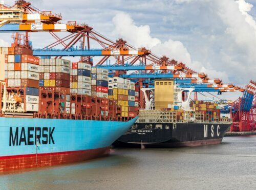 blue and red cargo ship on dock during daytime